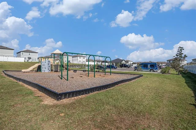 a view of a house with swimming pool and a yard