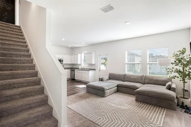 a living room with furniture and a potted plant