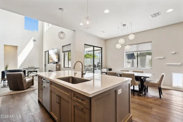 a kitchen with stainless steel appliances granite countertop a sink and a refrigerator