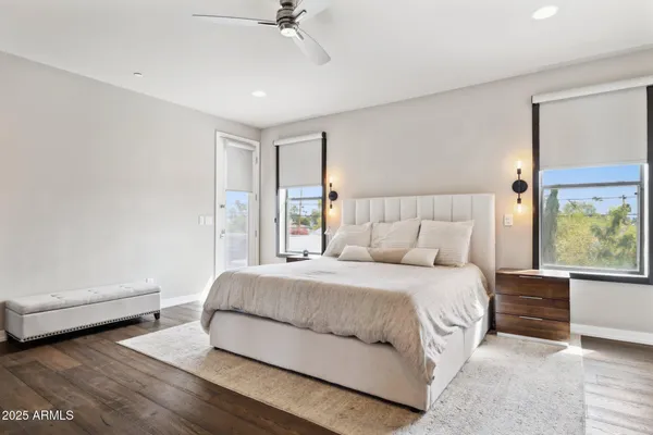 a bedroom with a large bed and a chandelier