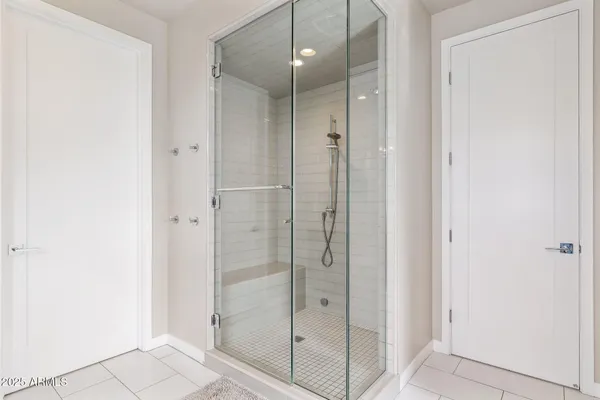 a bathroom with a shower and a glass door
