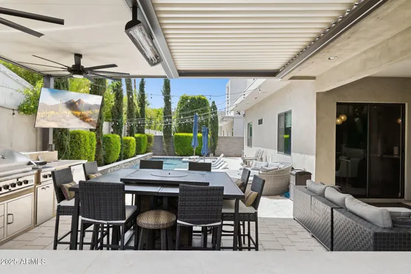a dining room with furniture a rug and a large window