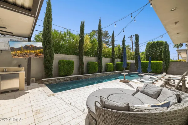 a view of swimming pool with outdoor seating