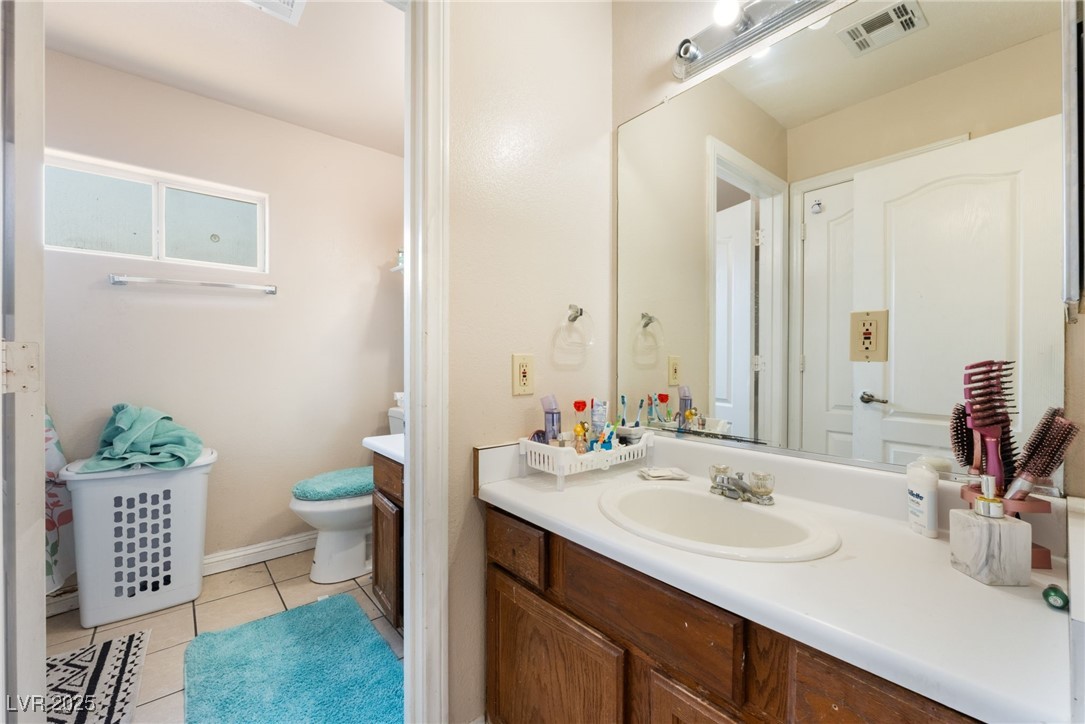 4656 East Desert Inn Road Las Vegas, NV 89121 - Photo 47 of 98 4650 E DI Bathroom featuring vanity and tile patterned floors