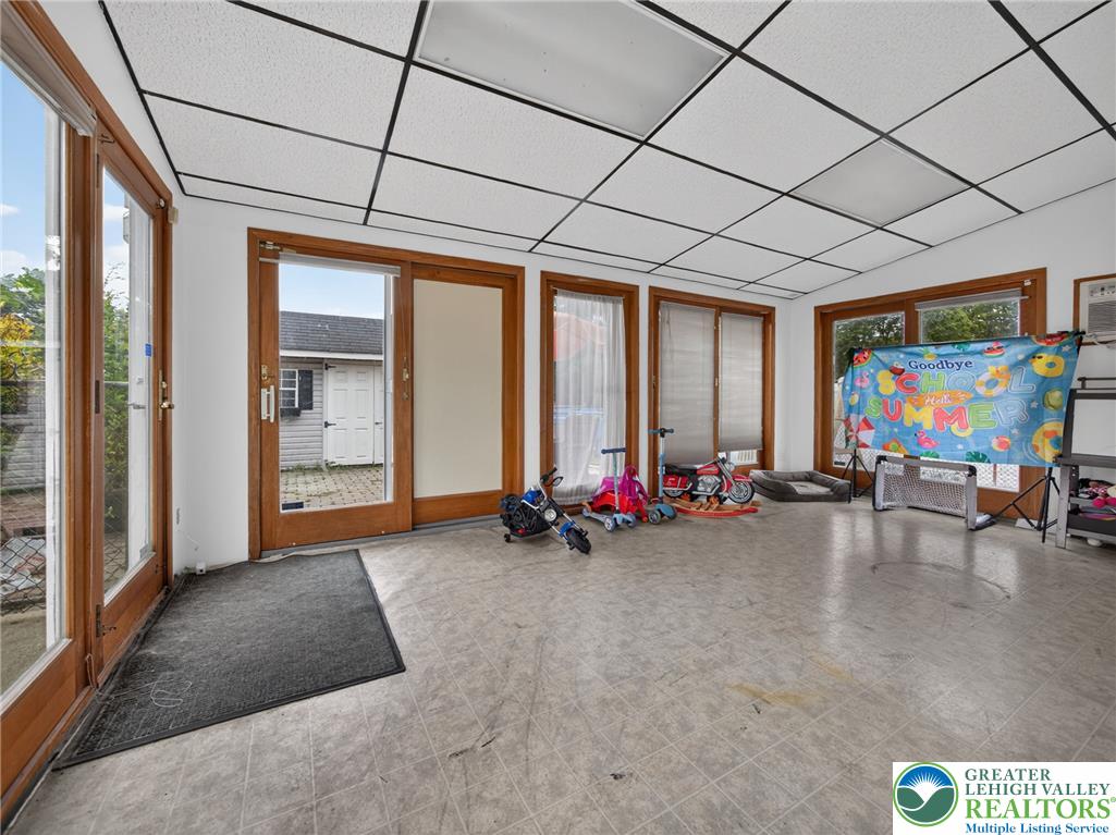 2628 Levans Road Coplay, PA 18037 - Photo 25 of 54 Sun-filled room with multiple large windows and glass doors offers versatile living space.