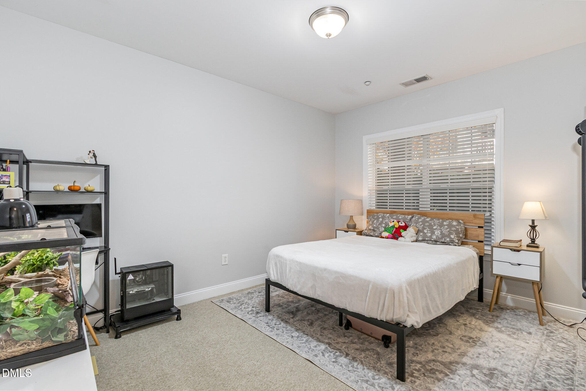 9211 Calabria Drive, Unit 117 Raleigh, NC 27617 - Photo 10 of 19 a bedroom with a bed and a window
