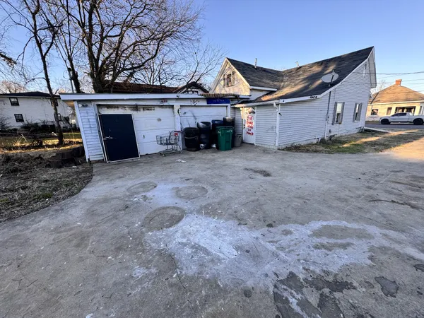 a view of a house with a yard and garage