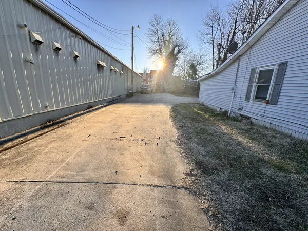 a view of backyard and wooden fence