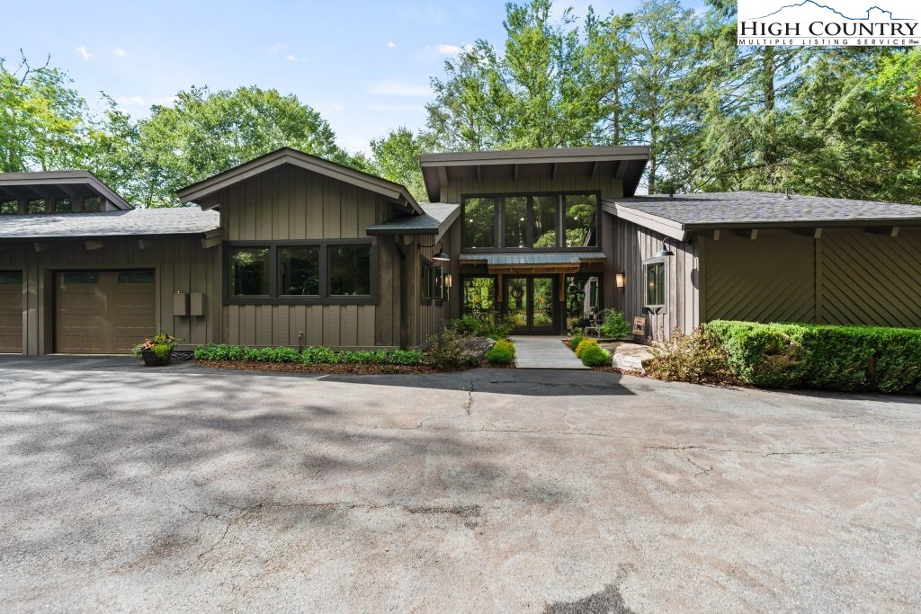 1325 Golf Course Road Linville, NC 28646 - Photo 1 of 46 a front view of a house with a yard and garage