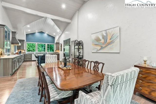 a dining room with furniture a window and wooden floor