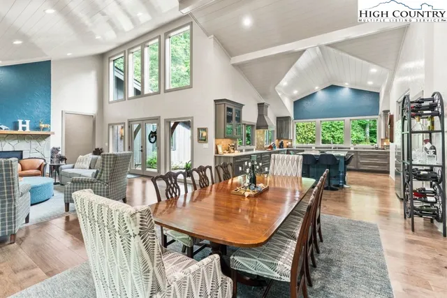 a dining room with furniture a rug and wooden floor