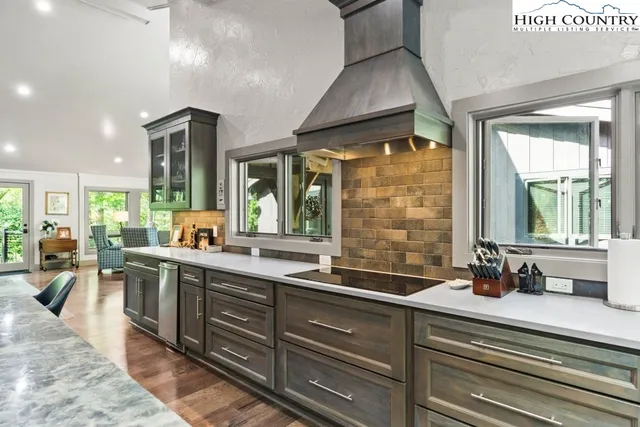 a large kitchen with a large window and stainless steel appliances