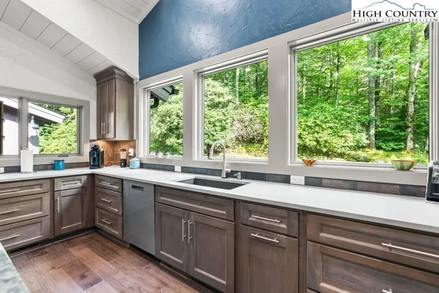 a kitchen with a sink and large window