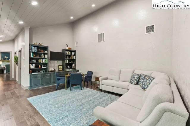 a living room with furniture and a book shelf
