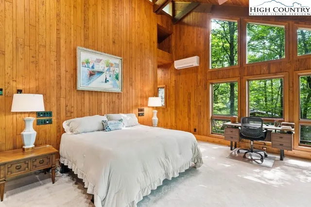 a spacious bedroom with a bed and a window