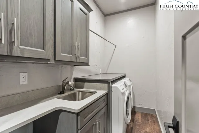 a kitchen with a sink a stove and cabinets