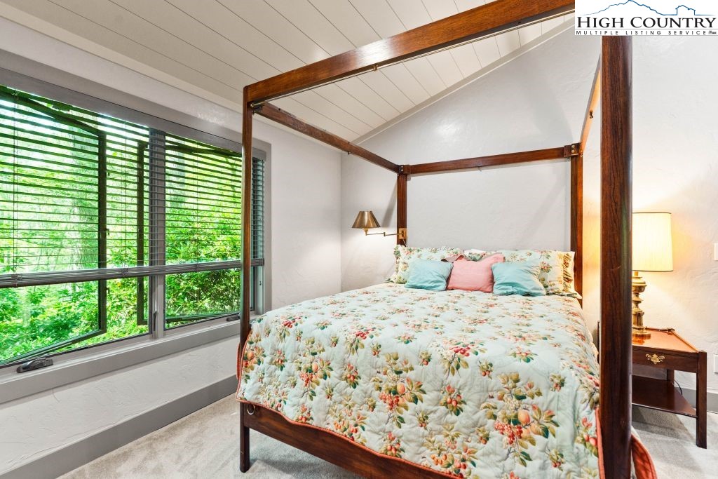 1325 Golf Course Road Linville, NC 28646 - Photo 35 of 46 a bedroom with a bed and a large window