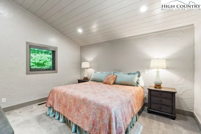 a bedroom with a bed and a night stand