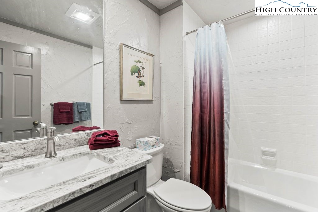 1325 Golf Course Road Linville, NC 28646 - Photo 42 of 46 a bathroom with a granite countertop sink toilet and shower