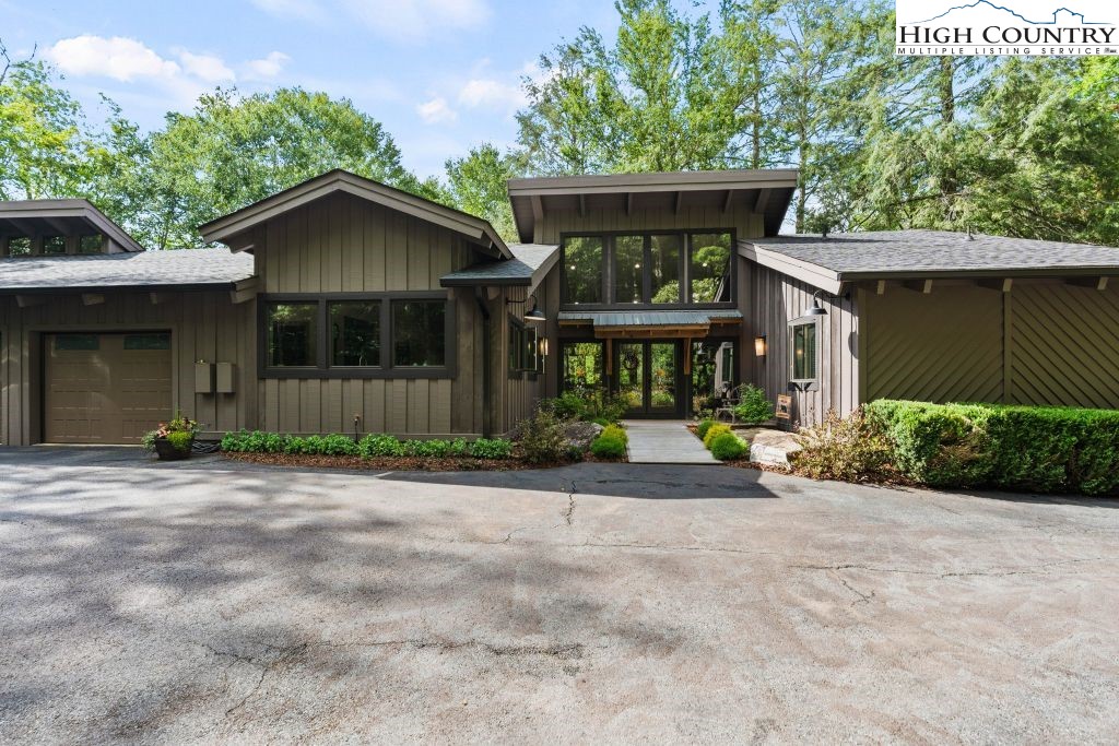 1325 Golf Course Road Linville, NC 28646 - Photo 6 of 46 a front view of a house with a yard and trees