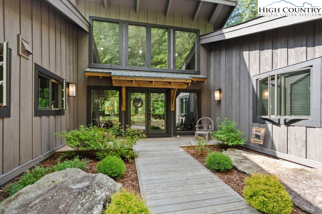 1325 Golf Course Road Linville, NC 28646 - Photo 9 of 46 a front view of a house with garden and plants