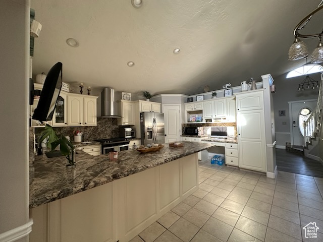 1874 South Main Street Orem, UT 84058 - Photo 4 of 15 Kitchen featuring decorative backsplash, stainless steel appliances, recessed lighting, a peninsula, and wall chimney range hood