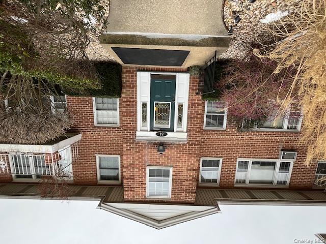 84 Shore Road, Unit D2 Port Washington, NY 11050 - Photo 1 of 12 a front view of a house with yard