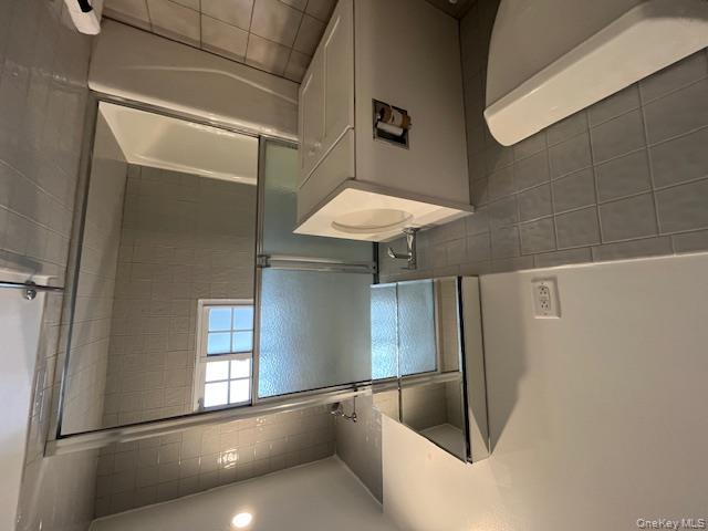 84 Shore Road, Unit D2 Port Washington, NY 11050 - Photo 12 of 12 a bathroom with a sink toilet and shower