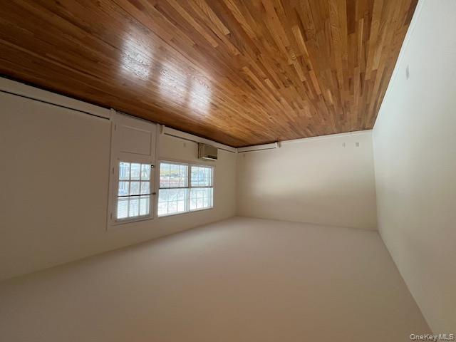 84 Shore Road, Unit D2 Port Washington, NY 11050 - Photo 3 of 12 an empty room with wooden floor and windows