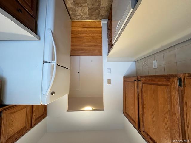 84 Shore Road, Unit D2 Port Washington, NY 11050 - Photo 8 of 12 a kitchen with a refrigerator a stove and a sink