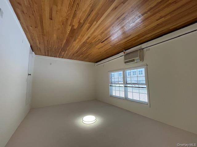 84 Shore Road, Unit D2 Port Washington, NY 11050 - Photo 10 of 12 an empty room with wooden floor and windows