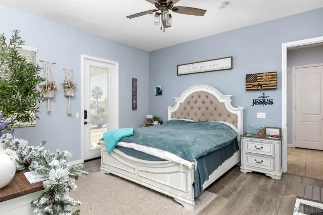 a bedroom with a bed and a chandelier