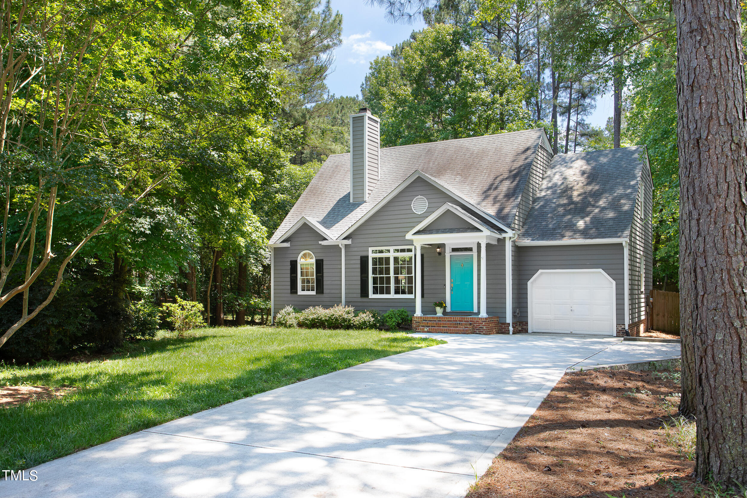 2002 Fountain Ridge Road Chapel Hill, NC 27517 - Photo 3 of 39 a front view of a house with a yard and trees