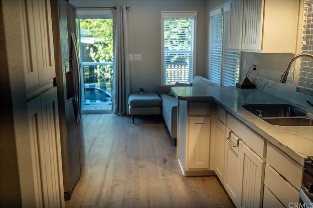 a kitchen with a refrigerator and a sink