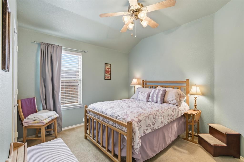 5491 Exeter Drive Prosper, TX 75078 - Photo 16 of 20 a bedroom with a bed and a chandelier