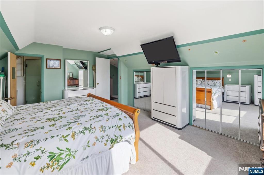 119 Overpeck Avenue Ridgefield Park, NJ 07660 - Photo 27 of 44 a bedroom with a bed and a flat screen tv
