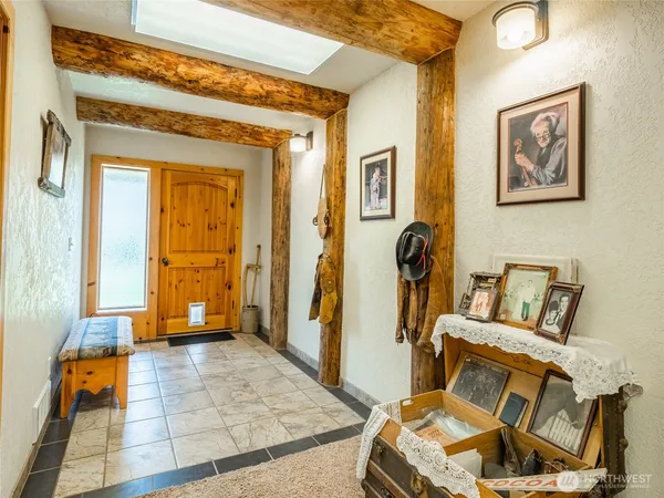 a living room with furniture and a painting on the wall