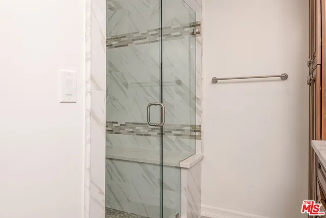 a bathroom with a glass shower door