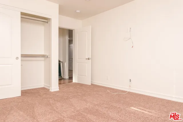 a bathroom with a granite countertop toilet a sink a mirror and shower
