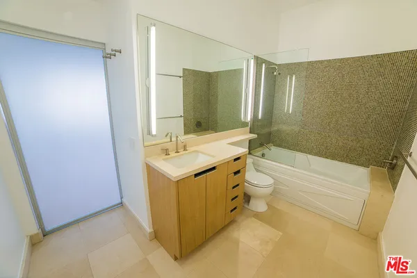 a bathroom with a double vanity sink toilet and shower