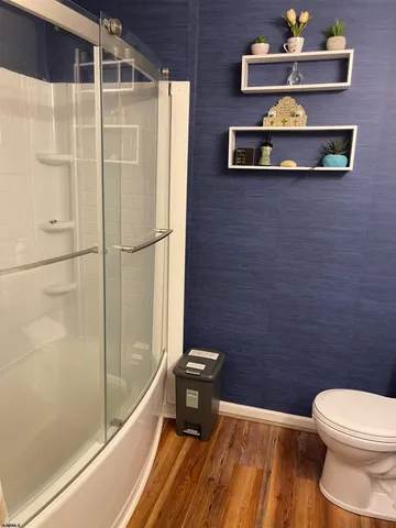 a bathroom with a toilet and a shower