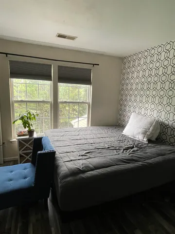 a bedroom with a bed and a window
