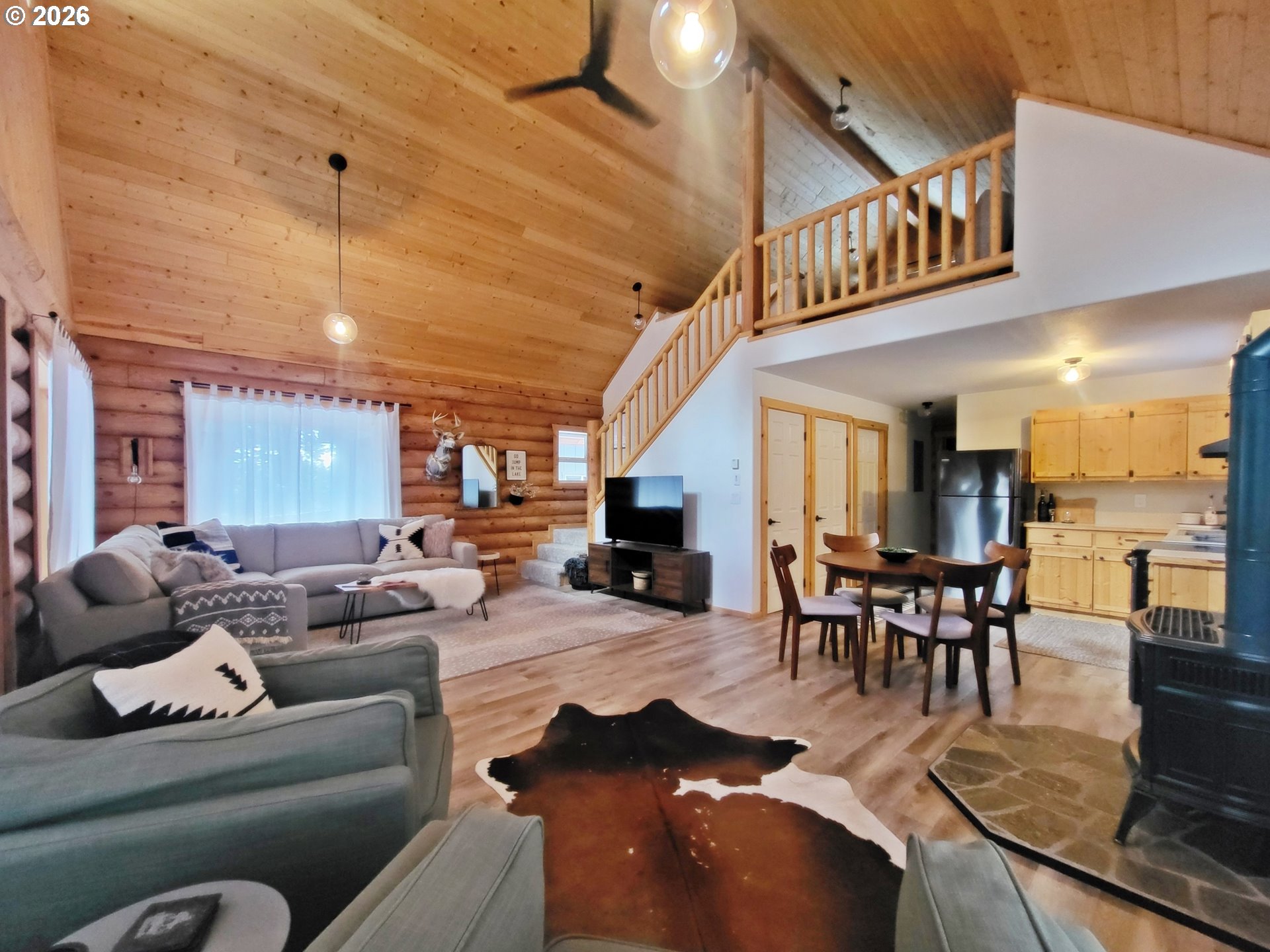 84730 Talmena Road Wallowa Lake, OR 97846 - Photo 12 of 25 a living room with furniture and a dining table