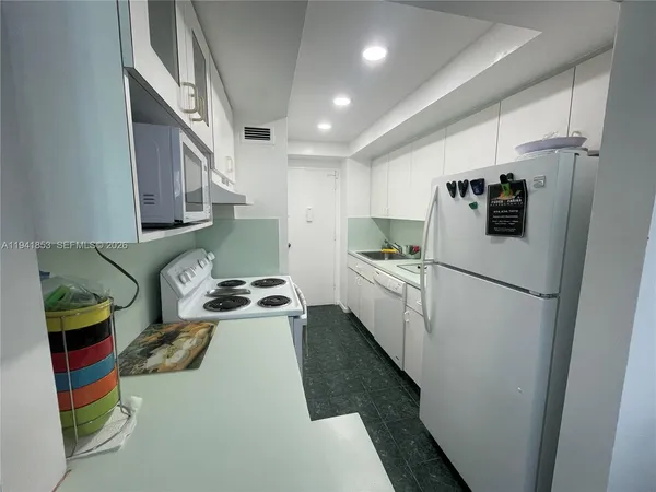 a kitchen with a refrigerator and a sink