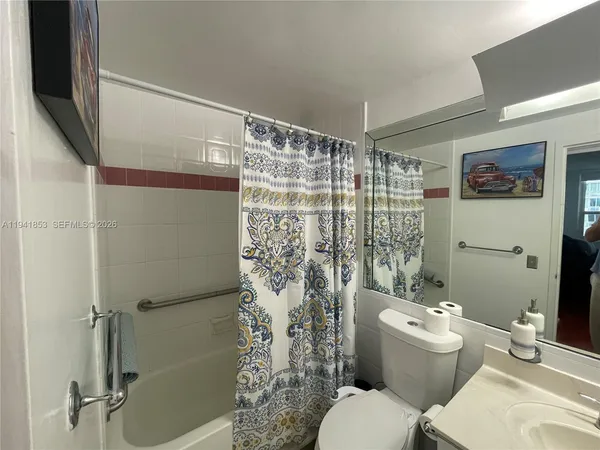 a bathroom with a toilet and shower