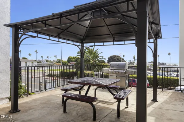 a view of a chairs and table in the back yard