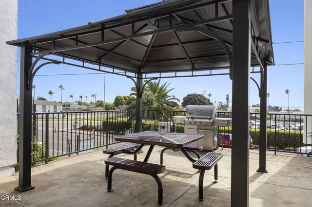 a view of a chairs and table in the back yard