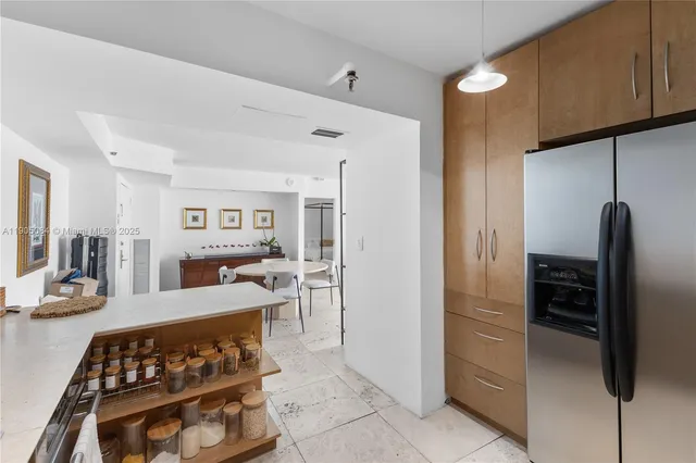 a kitchen with stainless steel appliances granite countertop a refrigerator and a stove top oven