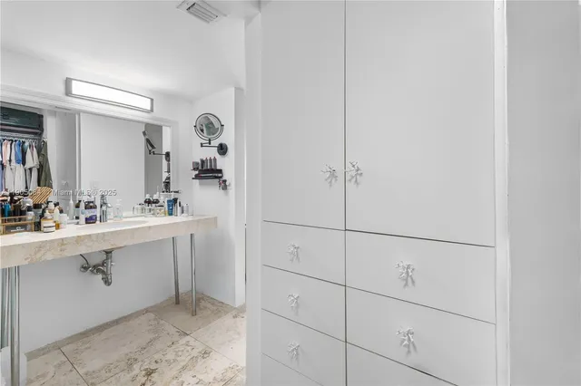 a bathroom with a sink and mirror