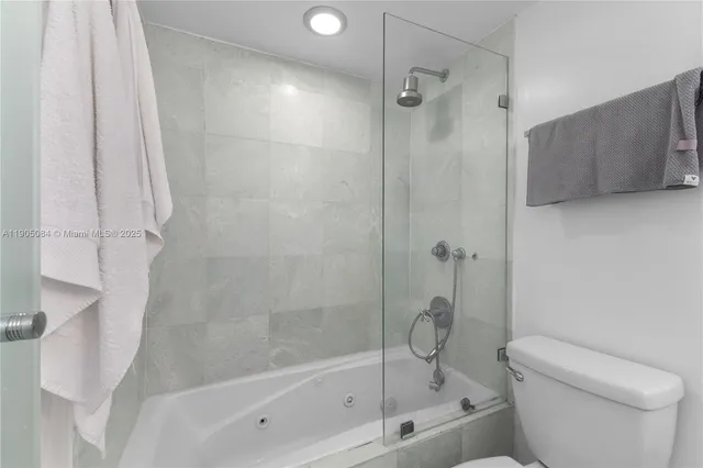 a bathroom with a shower and a toilet